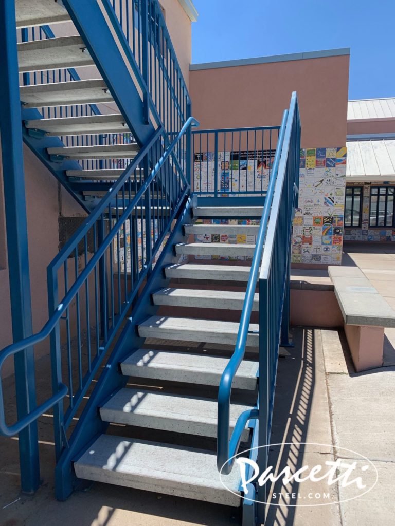 custom commercial steel stair system with integrated railings pre-cast concrete treads and perforated steel stair treads