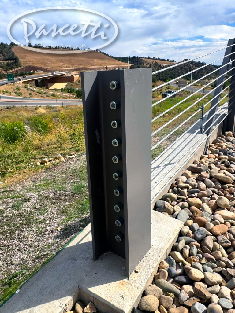 Large steel beam in concrete for parking lot roadway high tension cable barrier system for traffic control