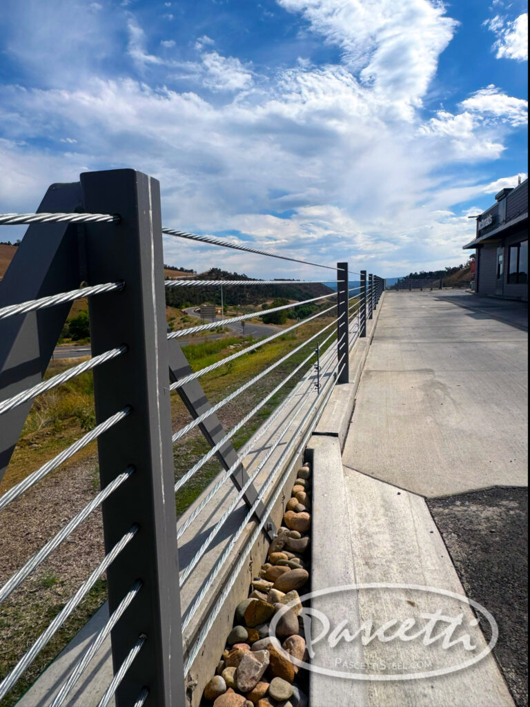 Vehicle protection with high tension cable barrier system in parking lot drive thru