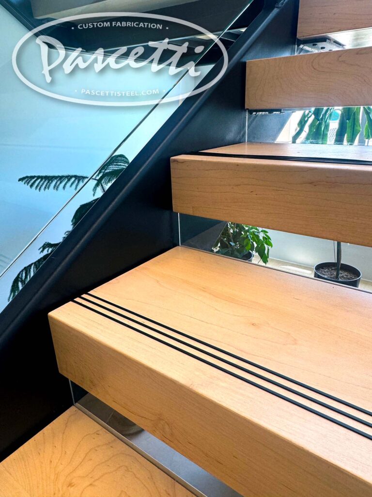 ADA compliant hardwood treads with glass risers. Cantilevered Stairs with Glass Railing