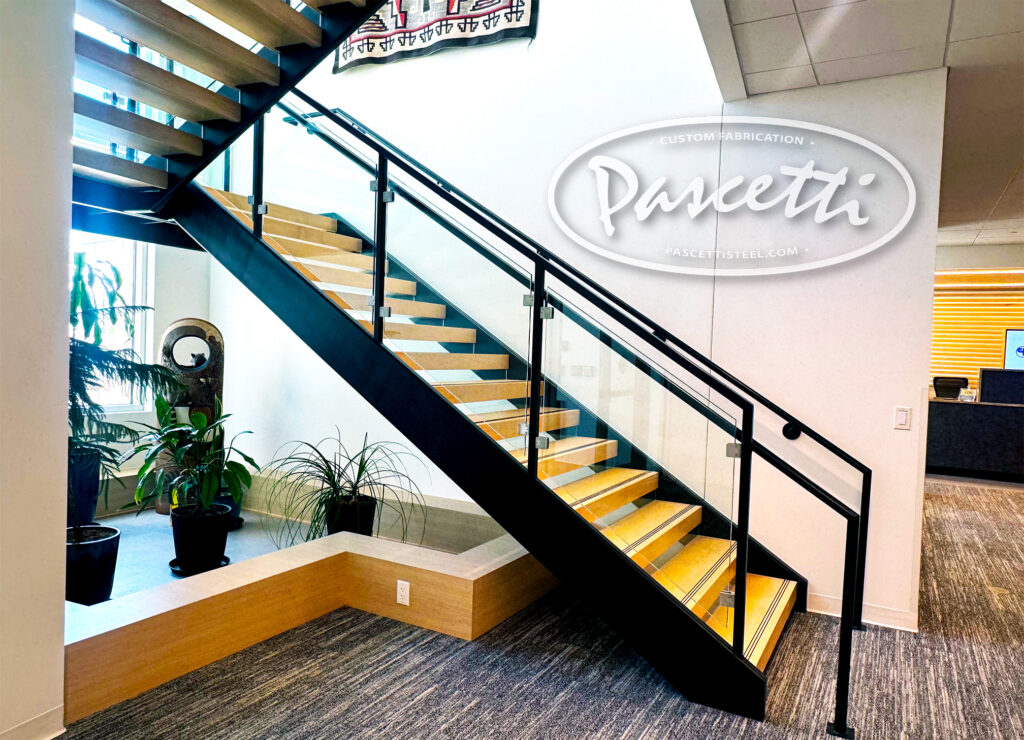 cantilevered steel stairs with glass railings featured